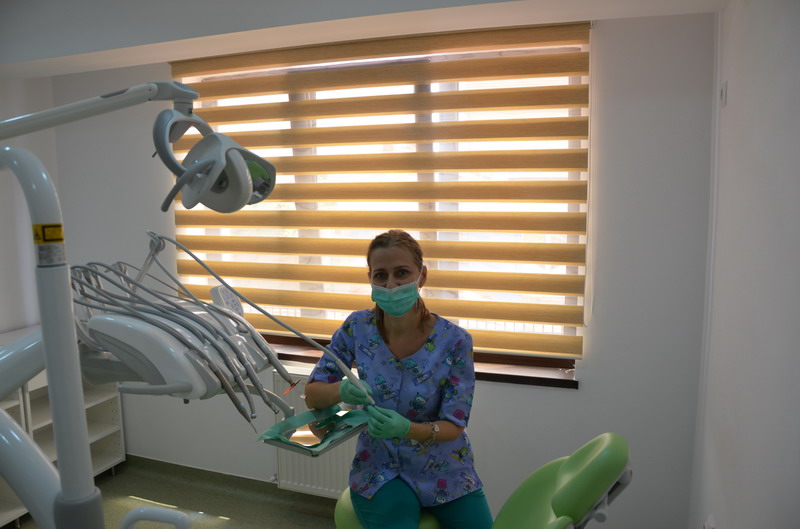 Dental treatment room with modern chair and overhead light